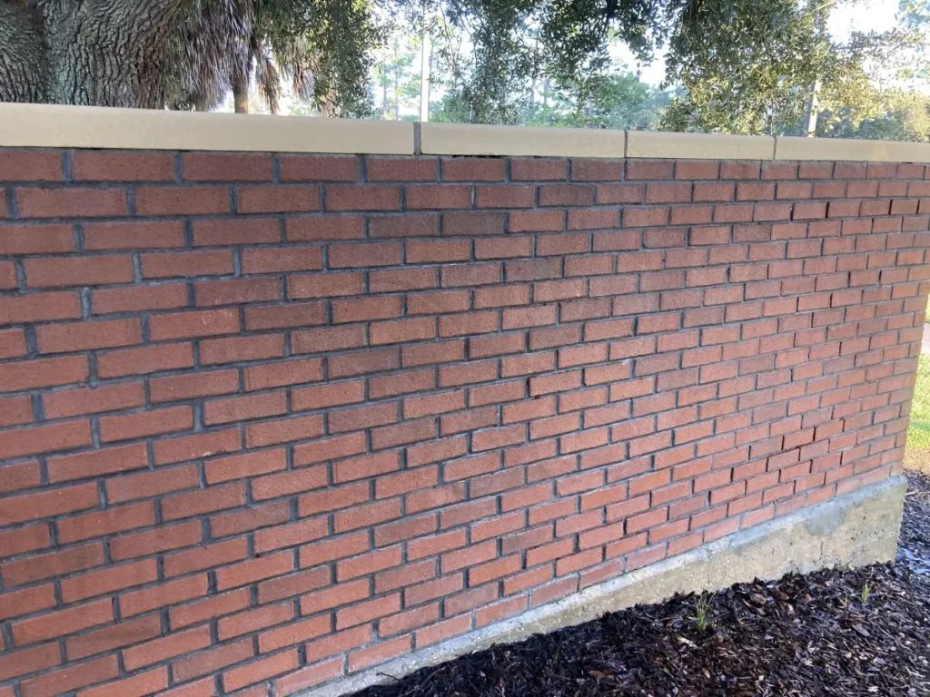 Same brick wall after pressure washing, graffiti fully removed
